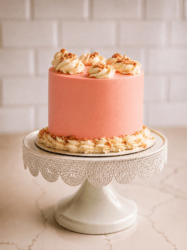 Elegant strawberry lemonade cake on pedestal stand
